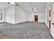 Spacious living room with high ceilings, ceiling fans, and neutral carpet ready for personalization at 2699 Audubon Ave, Deland, FL 32720