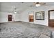 Expansive living room featuring high ceilings, ceiling fans, and easy access to the kitchen at 2699 Audubon Ave, Deland, FL 32720