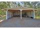 Open-sided outbuilding with gravel floor, featuring ample storage space for tools and equipment at 2699 Audubon Ave, Deland, FL 32720