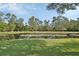 Picturesque pond with lily pads and lush green surroundings, reflecting the clear blue sky at 2699 Audubon Ave, Deland, FL 32720