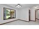 Bright room with a ceiling fan, large window offering outdoor views, and a neutral color scheme, suitable for versatile use at 2699 Audubon Ave, Deland, FL 32720