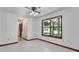 Spacious room with a large window, ceiling fan, and neutral decor, offering a versatile and inviting atmosphere at 2699 Audubon Ave, Deland, FL 32720