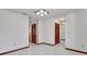 Neutral room with wood trim, tiled floors, and paneled closet doors, creating a clean and functional space at 2699 Audubon Ave, Deland, FL 32720