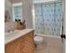 Stylish bathroom with marble countertop, modern faucet, vanity, patterned shower curtain at 272 Sunrise Blvd, Debary, FL 32713