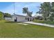 Inviting single-Gathering home showcasing a well-kept lawn and paved driveway leading to an attached garage at 272 Sunrise Blvd, Debary, FL 32713