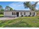 Charming single-story home featuring a well-maintained lawn, stone walkway, and attached garage at 272 Sunrise Blvd, Debary, FL 32713