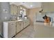 Efficient kitchen with white cabinets, appliances, tile floors, and plenty of natural light at 272 Sunrise Blvd, Debary, FL 32713
