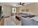 Comfortable living room with tile floors, ceiling fan, and view of the front yard through the window at 272 Sunrise Blvd, Debary, FL 32713