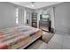 Calm bedroom features natural light, neutral paint and tile flooring with ample closet space at 272 Sunrise Blvd, Debary, FL 32713
