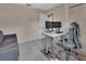Cozy room featuring desk setup, gray sofa, tile floor and door leading to another room at 272 Sunrise Blvd, Debary, FL 32713