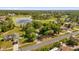 Aerial view features the home and neighborhood including pond and road at 2885 Newmark Dr, Deltona, FL 32738