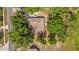 Birds eye view of a home with a neutral-colored roof surrounded by mature trees in a residential neighborhood at 2885 Newmark Dr, Deltona, FL 32738
