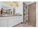 Bathroom featuring a vanity with drawers and cabinets and a tiled shower stall with a curtain at 2885 Newmark Dr, Deltona, FL 32738