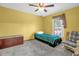 Bedroom with ample natural light, bed, trunk, and seating area at 2885 Newmark Dr, Deltona, FL 32738