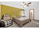 Cozy bedroom with a queen bed, a chair, and a view to the bathroom area at 2885 Newmark Dr, Deltona, FL 32738