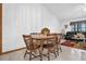 Bright dining room is complete with hardwood table and access to the living room at 2885 Newmark Dr, Deltona, FL 32738