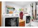 A functional laundry room featuring a side-by-side washer and dryer and wire shelving at 2885 Newmark Dr, Deltona, FL 32738