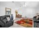 Bright living room featuring a modern area rug, seating, and a dining area with natural light at 2885 Newmark Dr, Deltona, FL 32738