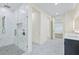 Bathroom with glass walk-in shower and marble floors and walls at 2894 Hardy Ave, New Smyrna Beach, FL 32168