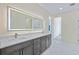 Modern bathroom with double vanity, white quartz countertops, light-up mirror, and marble flooring at 2894 Hardy Ave, New Smyrna Beach, FL 32168