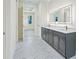 Bathroom featuring double vanity with gray cabinets and white marble flooring at 2894 Hardy Ave, New Smyrna Beach, FL 32168