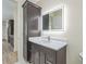 Bathroom with vanity, mirrored cabinet, white countertop and marble floor at 2894 Hardy Ave, New Smyrna Beach, FL 32168