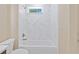 Bright bathroom featuring marble-tiled shower, tub, and floors at 2894 Hardy Ave, New Smyrna Beach, FL 32168
