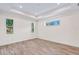 Bright bedroom with light wood floors, recessed lighting and multiple windows with green views at 2894 Hardy Ave, New Smyrna Beach, FL 32168