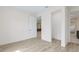 Bedroom with light wood floors, closet, white walls, and white base trim at 2894 Hardy Ave, New Smyrna Beach, FL 32168