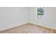 Bedroom with light wood floors, white walls and a large bright window at 2894 Hardy Ave, New Smyrna Beach, FL 32168