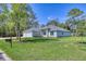 Inviting home with a well-manicured lawn, a three car garage and lush landscaping at 2894 Hardy Ave, New Smyrna Beach, FL 32168