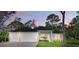 Charming single-story home featuring a three-car garage and lush landscaping, perfect for suburban living at 2894 Hardy Ave, New Smyrna Beach, FL 32168