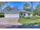 Lovely home featuring a three car garage, manicured lawn, and an attractive entrance at 2894 Hardy Ave, New Smyrna Beach, FL 32168