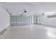Spacious garage features epoxy flooring and ample room for parking and storage at 2894 Hardy Ave, New Smyrna Beach, FL 32168