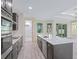 Modern kitchen with stainless appliances, white quartz countertops, and gray wood flooring at 2894 Hardy Ave, New Smyrna Beach, FL 32168