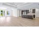 Open-concept kitchen with a large island, stainless steel appliances, and seamless flow to the living area for modern living at 2894 Hardy Ave, New Smyrna Beach, FL 32168