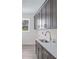 Laundry room with gray cabinets, white countertop, stainless sink, and a window at 2894 Hardy Ave, New Smyrna Beach, FL 32168