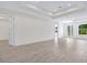 Spacious living room with tray ceiling, neutral paint, and light wood flooring throughout at 2894 Hardy Ave, New Smyrna Beach, FL 32168