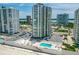 Beautiful aerial view of a beachfront condo building with a pool, parking, and easy beach access at 2987 S Atlantic Ave # 903, Daytona Beach, FL 32118
