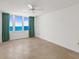 Light-filled bedroom featuring tile flooring, ocean views, and classic ceiling fan at 2987 S Atlantic Ave # 903, Daytona Beach, FL 32118