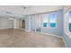 Spacious living room boasts tile floors, mirrored walls, a ceiling fan, and sliding glass doors to a balcony with ocean views at 2987 S Atlantic Ave # 903, Daytona Beach, FL 32118