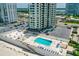 Condo community pool and beach access, featuring ample lounge seating and nearby parking at 2987 S Atlantic Ave # 903, Daytona Beach, FL 32118