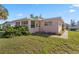 Cozy single-story home with well-kept lawn; features a quaint front entrance and mature landscaping at 3267 S Peninsula Dr, Daytona Beach, FL 32118
