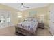 Bedroom with yellow walls, wood-look floors, ceiling fan, and a queen size bed at 3315 S Atlantic Ave # 1406, Daytona Beach Shores, FL 32118
