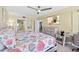 Bright bedroom has a dresser with TV, a workspace, and ensuite bathroom access at 3315 S Atlantic Ave # 1406, Daytona Beach Shores, FL 32118