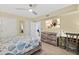 Bedroom with queen size bed, ceiling fan, a TV, and an ocean view through french doors at 3315 S Atlantic Ave # 1406, Daytona Beach Shores, FL 32118