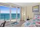 This bedroom has a desk and ocean view balcony for enjoying sunrises and sunsets at 3315 S Atlantic Ave # 1406, Daytona Beach Shores, FL 32118