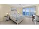 Bedroom featuring a comfortable bed, ocean view balcony, and desk at 3315 S Atlantic Ave # 1406, Daytona Beach Shores, FL 32118