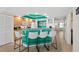Eat-in kitchen with teal island, pendant lights, seating, and appliances at 3315 S Atlantic Ave # 1406, Daytona Beach Shores, FL 32118