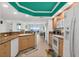 Open kitchen layout with wood cabinets, granite counters, and an ocean view at 3315 S Atlantic Ave # 1406, Daytona Beach Shores, FL 32118